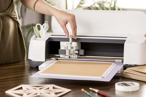 Front view of Cricut knife blade and drive housing installed in white Cricut Maker cutting machine