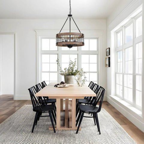 Dining room with Dope Rustic Farmhouse 19 Inch Chandelier With Wood And Black Metal Arms, over light wood table and black chairs.