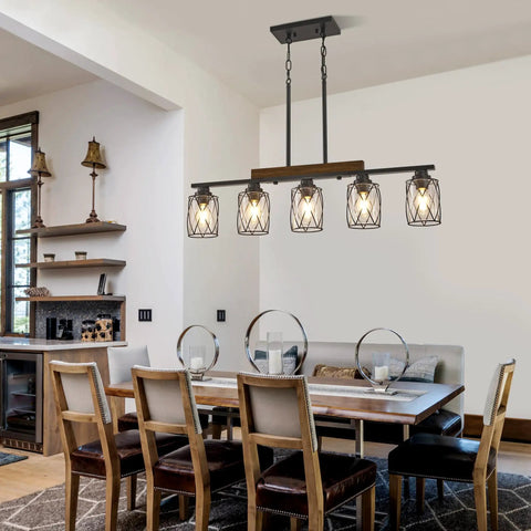 The Real Deal Five Light Farmhouse Chandelier With Slick Vintage Iron Frame And Crisp Clear Shades Giving Off Clean Modern Industrial Lighting Vibe For Dining Room Table Centerpiece, over a dining table.