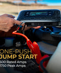 Person using Portable Car Jump Starter With 600 Amp Peak, 130 Psi Tire Inflation, 59.9Wh USB Power Bank, Big Display under a car hood