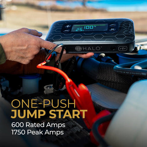 Person using Portable Car Jump Starter With 600 Amp Peak, 130 Psi Tire Inflation, 59.9Wh USB Power Bank, Big Display under a car hood