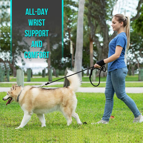 Person wearing All Day Comfort Wrist Wrap For Carpal Tunnel And Arthritis Relief walking a dog in a park.