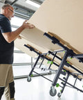 Man using Beast Mobile Saw Table And Work Bench STM 1800 205183 for sheet material cutting in a workshop.