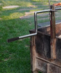 Revolving Handle Knob Grip For BBQ Grills And Woodworking Tools, attached to a rotisserie setup in a garden