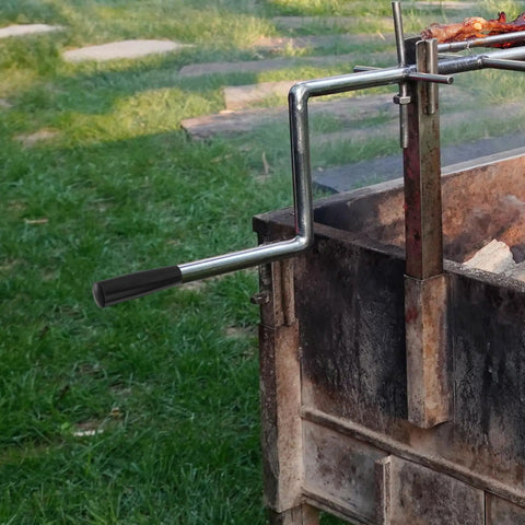 Revolving Handle Knob Grip For BBQ Grills And Woodworking Tools, attached to a rotisserie setup in a garden