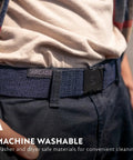 Person wearing Original Unisex Adventure Belt with heavy duty elastic webbing and non metal travel buckle in medium brown