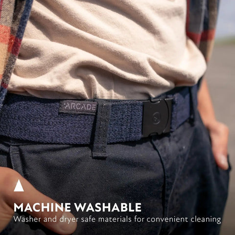 Person wearing Original Unisex Adventure Belt with heavy duty elastic webbing and non metal travel buckle in medium brown