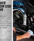 Heavy Metal Polish Restorer And Protectant For Chrome Aluminum Stainless Steel Brass Silver And More Cleans Restores Removes Oxidation And Stains Safe For Cars Trucks Motorcycles RVs And Boats 16 Oz being used on a motorcycle exhaust pipe