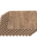 Stack of Wood Grain Interlocking Foam Floor Tiles 24x24 Inch Three Eighths Inch Thick Anti Fatigue Mats with wood texture.