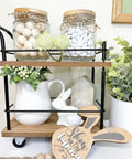 Dope Vintage Two Tier Mini Wood Coffee Bar Cart With Smooth Rolling Wheels And Spacious Dual Shelves For Any Cozy Hangout Or Quick Serve Beverage Station with decorations.