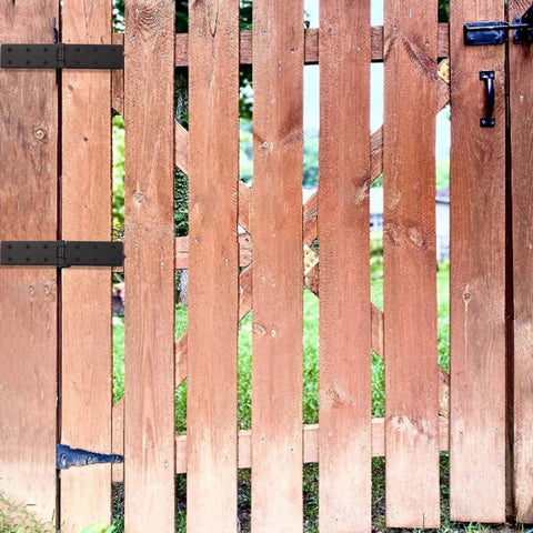 Wooden gate with installed black gate hinges, weather-resistant for outdoor use. Gate Hinges With Screws Black Adjustable Hardware Hinges Kit For Barn Doors Fences And Yard Gates Durable Two Pack Easy To Install Modern Black Finish For Heavy Load Gates And Wooden Fences Weather Resistant Outdoor Use