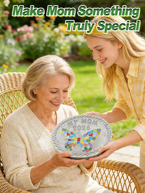 Woman gifting a decorated stone made with All In One 10 Inch Stepping Stone Kit With Cement Mix Concrete Molds Mosaic Tiles Carving Tools Letter And Number Stamps Gloves And Mat Create Outdoor Garden Walkway Stones For DIY Craft Lovers And Mothers Day Gift to an elderly lady sitting on a wicker chair in a garden.