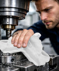 Person using Recycled White Fleece Rags 50 Lb Box For Cleaning And Polishing Auto Home And Workshop Low Lint Mad Absorbent Wipes on machinery.