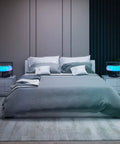 Bedroom scene with two bedside lamps, including Bedside Lamp With Wireless Charger And Bluetooth Speaker For Bedroom RGB Dimmable Nightstand Light With Qi Charging Pad And Immersive Audio For Cozy Ambient Vibes, illuminating in blue and purple tones.