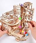 Hands assembling the Mechanical Marble Run Puzzle Kit With Chain Hoist 335 Pieces And 8 Marbles A DIY Wood Model Building Kit