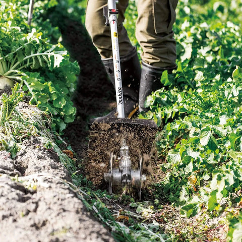 Gardener using KR401MP Cultivator Couple Shaft Attachment For Power Head Compact 9 Inch 6 Tine Steel Blade in garden bed