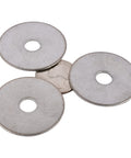Top-down view of four stainless Fender washers, 1-1/4 in OD with 5/16 in hole, 18-8 (304) stainless steel.