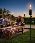 Outdoor gathering with 55 Inch Outdoor Oil Torch Lamps Four Pack Rustproof Stainless Steel Citronella Torches in backyard setting