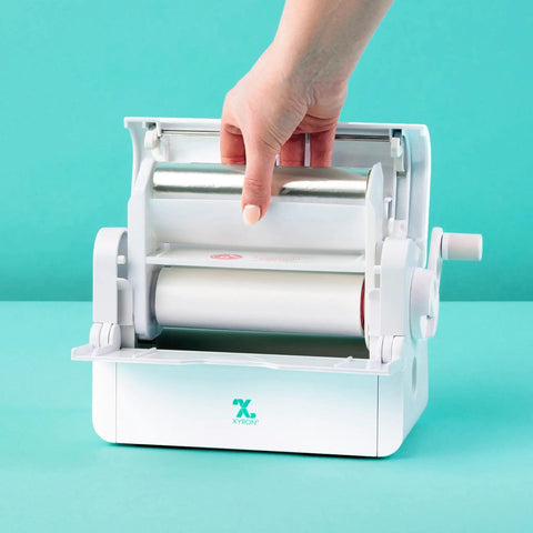 Big League Permanent Adhesive Refill Cartridge For 5 X 18 Foot Creative Station being installed in a crafting machine.