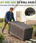 Man lifting Outdoor Resin Storage Deck Box Lockable And UV Resistant 85 Gallon Bin with wheels showing mobility feature