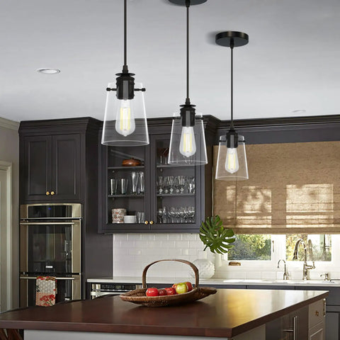 Black Pendant Lights For Kitchen Island, Modern Glass Hanging Fixture with adjustable drop cord above a kitchen island.