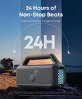 Outdoor Bluetooth Speaker With Crankin Bass Subwoofer And BassUp 2.0 80W Power For Camping And Beach IPX7 Waterproof And Floatable 24 Hour Playtime RGB Lights USB C Custom EQ Portable Audio For Any Adventure, shown on a rocky landscape beside a lake.