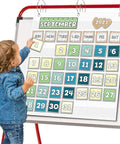 Child interacts with Durable Nylon Classroom Calendar Pocket Chart For 2.75 By 2.75 Cards With 24 Inch Hanging Ideal For Homeschool And School Use A Real Space Saver And Daily Schedule Helper For Classroom Organization Must Have hanging on easel.