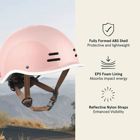 Blush kids bike helmet with built-in visor and reflective straps, mountain background, EPS foam lining, safe lightweight headgear, 49-53 cm.