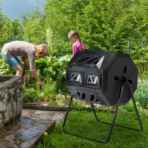 42 Gallon Outdoor Dual Chamber Compost Tumbler With Sliding Doors No Sweat Heavy Duty Rotating Batch Composter in a garden setting