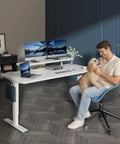 Adjustable Height Standing Desk With Raised Monitor Platform And Sleek Cable Tray For A Sick Home Office Setup That Will Keep Your Workspace Dope And Totally Clutter Free, featuring dual monitors and a man with a dog.