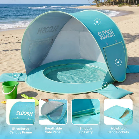 Baby Beach Tent Pop Up Shade Pool With UPF 50 UV Protection Sun Shelter For Infants on a sandy beach with green bucket.