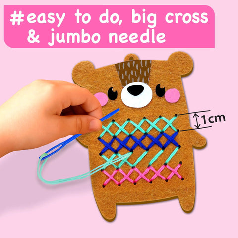 Child using Beginner Needlepoint Cross Stitch Kit For Kids Ages Five To Eight with jumbo needle on bear pattern.