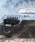 Eudora Waterproof Winch Cover Tailgate For 2500 To 6000 Lb Electric Truck Winches on a Jeep in muddy terrain.