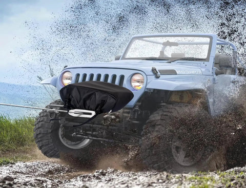 Eudora Waterproof Winch Cover Tailgate For 2500 To 6000 Lb Electric Truck Winches on a Jeep in muddy terrain.