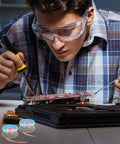 Technician using Six Pack 5Ft Solder Wick Braided Desoldering Wicks With Flux No Clean For Electronics PCB Repair on circuit board