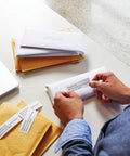 No Sweat Direct Thermal Label Printer With Zero Ink Hassles used for labeling envelopes in a mail room setting.