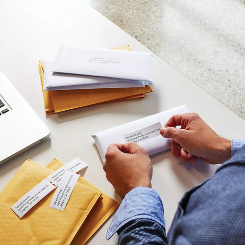 No Sweat Direct Thermal Label Printer With Zero Ink Hassles used for labeling envelopes in a mail room setting.