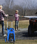 Children using Electric High Pressure Washer 3500 PSI 2.6 GPM With 25 Foot Hose And Hose Reel Four Interchangeable Nozzles outdoors