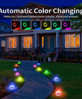 Colorful Sun Powered Solar Ground Lights 12 Pack with 8 LED In-Ground Disk Lights along a pathway at night