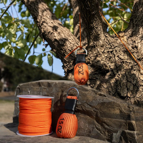 Arborist Throw Line Kit With 15 Oz Throw Weight And 196 Ft Paracord Rope, visible against tree for precise climbing setup