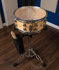 Hardcore Adjustable Snare Drum Tripod Stand With Double Braced Alloy Frame And Drumstick Pouch Slick Portable Practice Pad Rack Fitting Ten To Fourteen Inches setup showing snare drum on tripod with drumsticks holder.