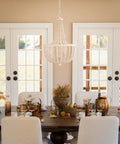 Dumas 3 Light Coastal Boho Chandelier With Weathered White Beads And Exposed Bulbs For A Cozy Vibe above dining table