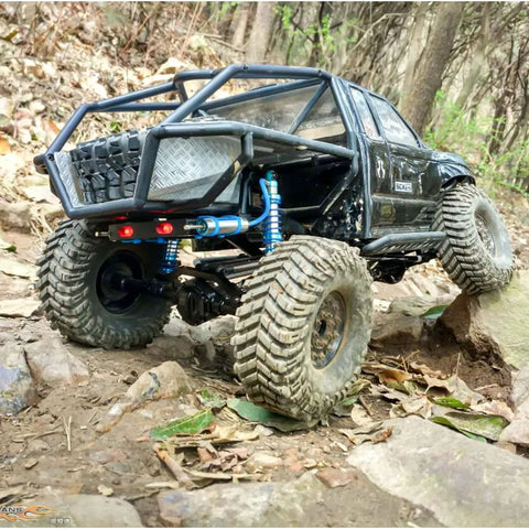 RC crawler with Adjustable Oil Piggyback RC Shock Absorber 70-123mm, climbing rocks, shows rear suspension detail.