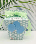 Gift box made with the Milk Box Gift Box Die Cut Set For Paper Craft And Scrapbooking, decorated with blue balloons and green ribbon.