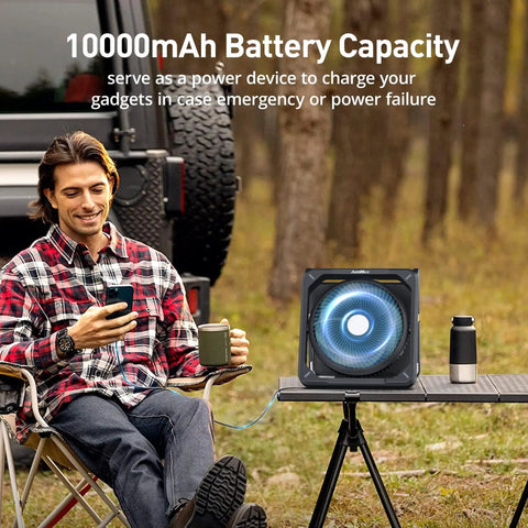 A man sitting by 11.5 Inch Portable Solar Powered Fan With Battery Backup For Camping Outdoor Travel Includes Solar Charger Timer And Lantern Perfect For Sleeping In Tents Cars Beaches Or During Hurricanes Keeps You Cool Anywhere