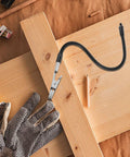 Alligator Clamp Welding Holder With Adjustable Flexible Arm And Magnifying Lamp Clip on a wooden workbench with tools.