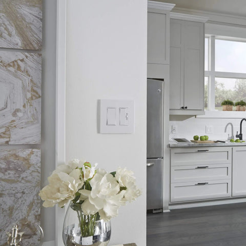 Radiant 0 To 10V Preset Decorator Rocker Dimmer Switch for fluorescent fixtures in a modern kitchen with white cabinets.