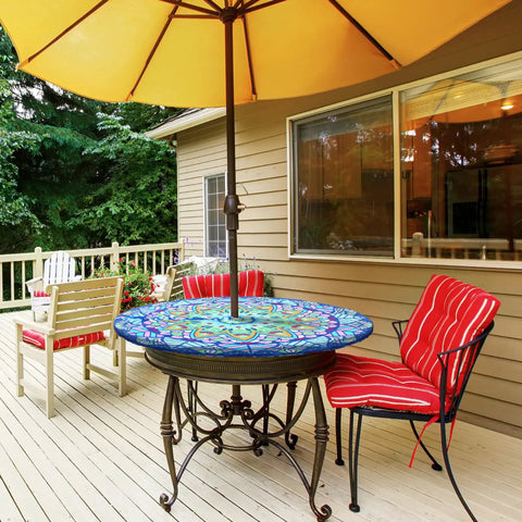 Outdoor table with mandala design tablecloth featuring an umbrella hole, hidden zipper, and elastic edge on a patio table.