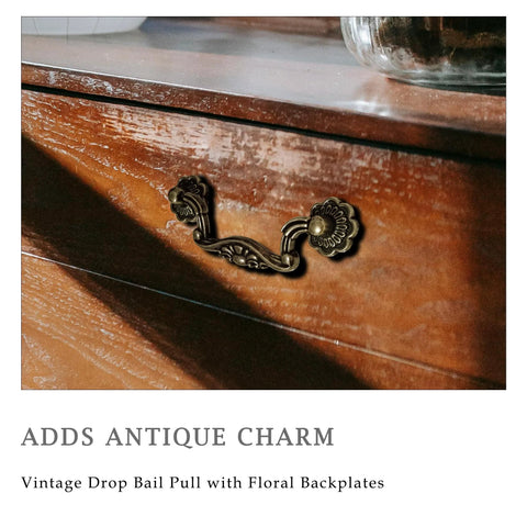 Six Pack Antique Brass Drop Bail Pulls With Vintage Floral Base Plates on wooden dresser for furniture renovation