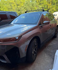 BMW SUV with installed BMW Roof Rack Cross Bars For iX 2020 And Up No Drilling Aluminum T Slot Design Lockable 330 Lbs Load Capacity